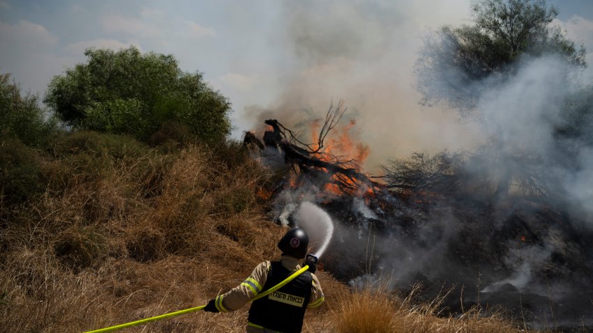 An Israeli firefighter works to extinguish a fire burning in an area, following an attack from Lebanon, near the Kibbutz Snir, northern Israel, Monday, Sept. 16, 2024.