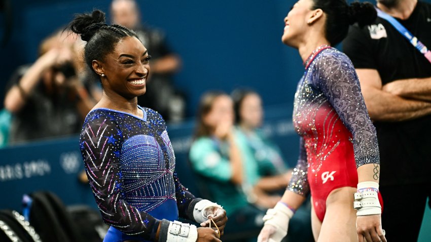 Simone Biles and Sunisa Lee smile during the artistic gymnastics women's all around final during the Paris 2024 Olympic Games at the Bercy Arena in Paris, on August 1, 2024.