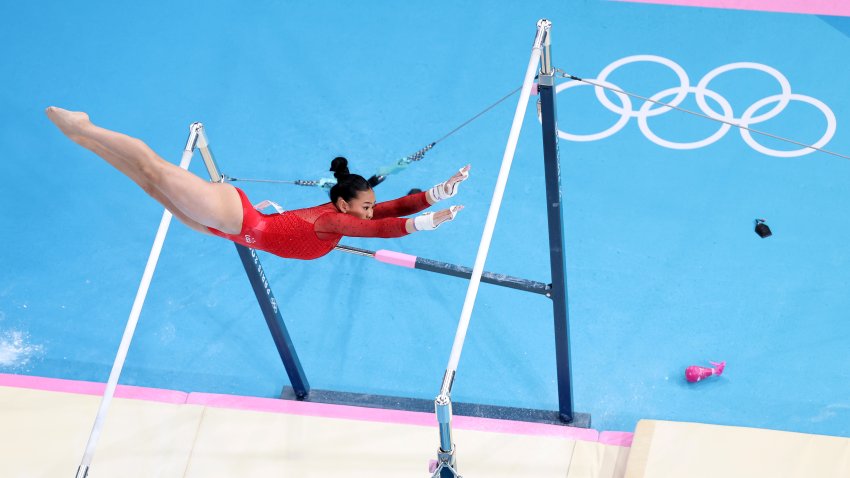 Suni Lee competes in uneven bars