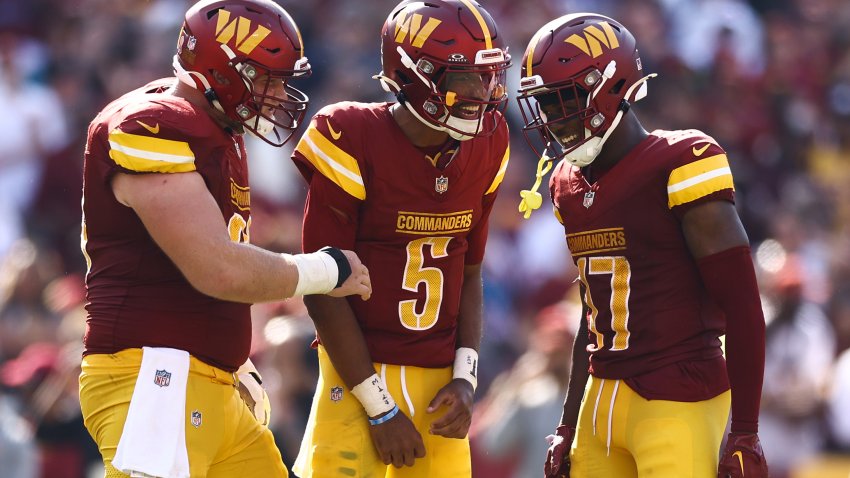 LANDOVER, MARYLAND – SEPTEMBER 15: Tyler Biadasz #63, Jayden Daniels #5 and Terry McLaurin #17 of the Washington Commanders react during the fourth quarter against the New York Giants at Northwest Stadium on September 15, 2024 in Landover, Maryland. (Photo by Tim Nwachukwu/Getty Images)