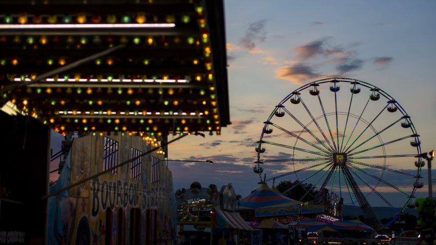 WASHINGTON, USA – SEPTEMBER 15: The sun sets over the amusement rides at The Great Frederick Fair in Frederick, Md., United States on September 15, 2017. (Photo by Samuel Corum/Anadolu Agency/Getty Images)